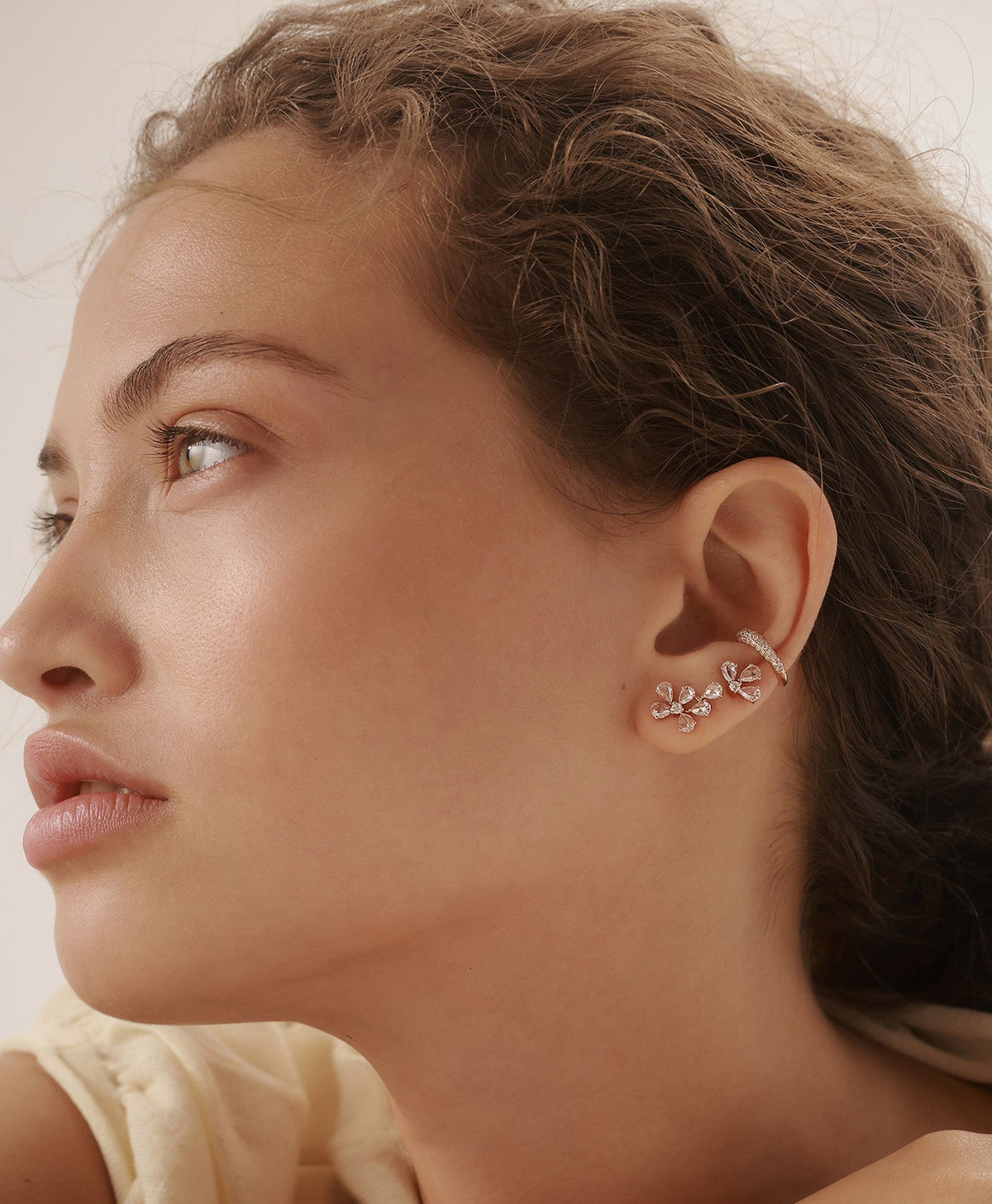 BIANCA asymmetrical diamond earring featured in layered ear jewelry composition on model