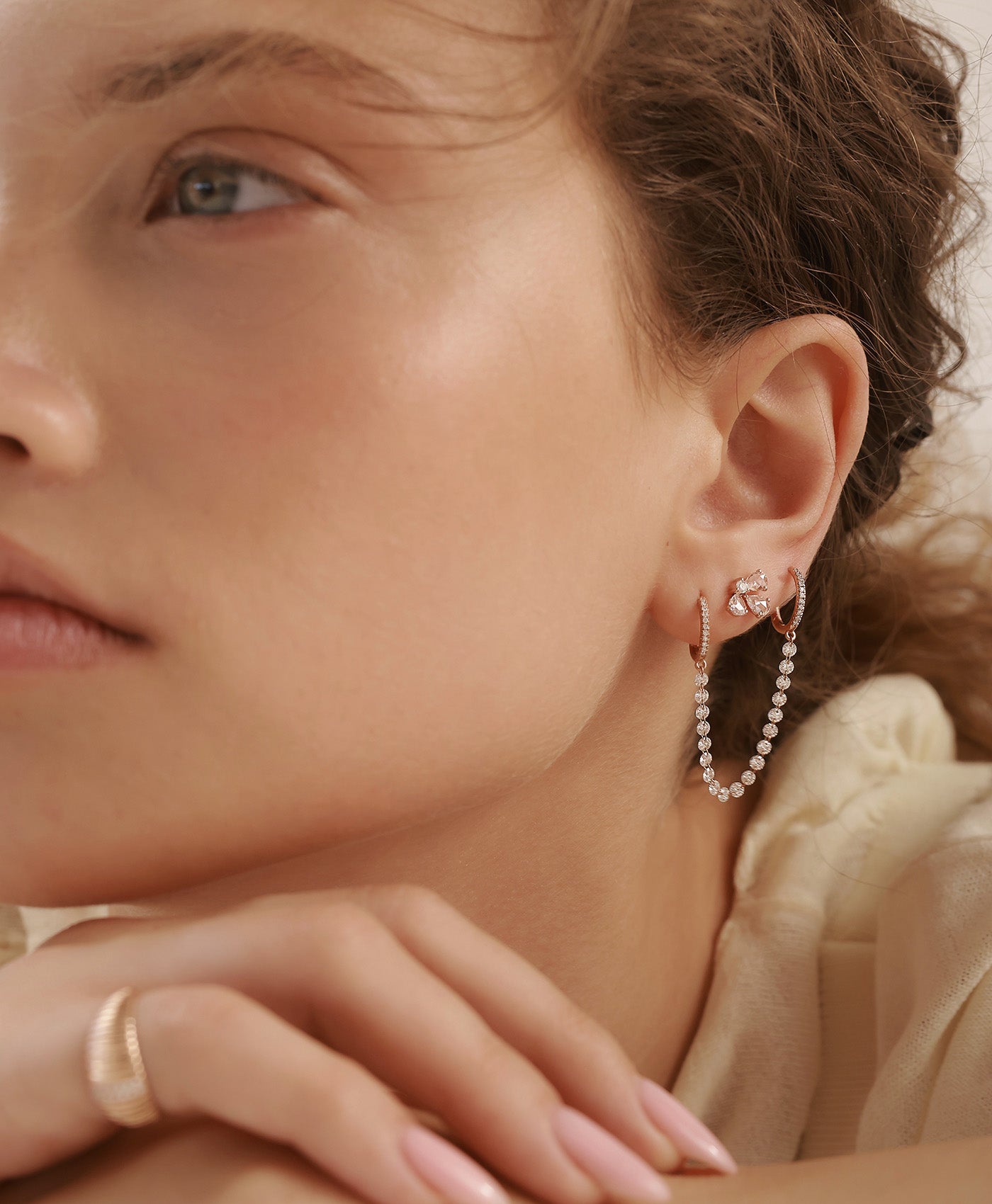 GIA rose gold diamond earring styled with TWIN diamond earrings in curated ear composition on model
