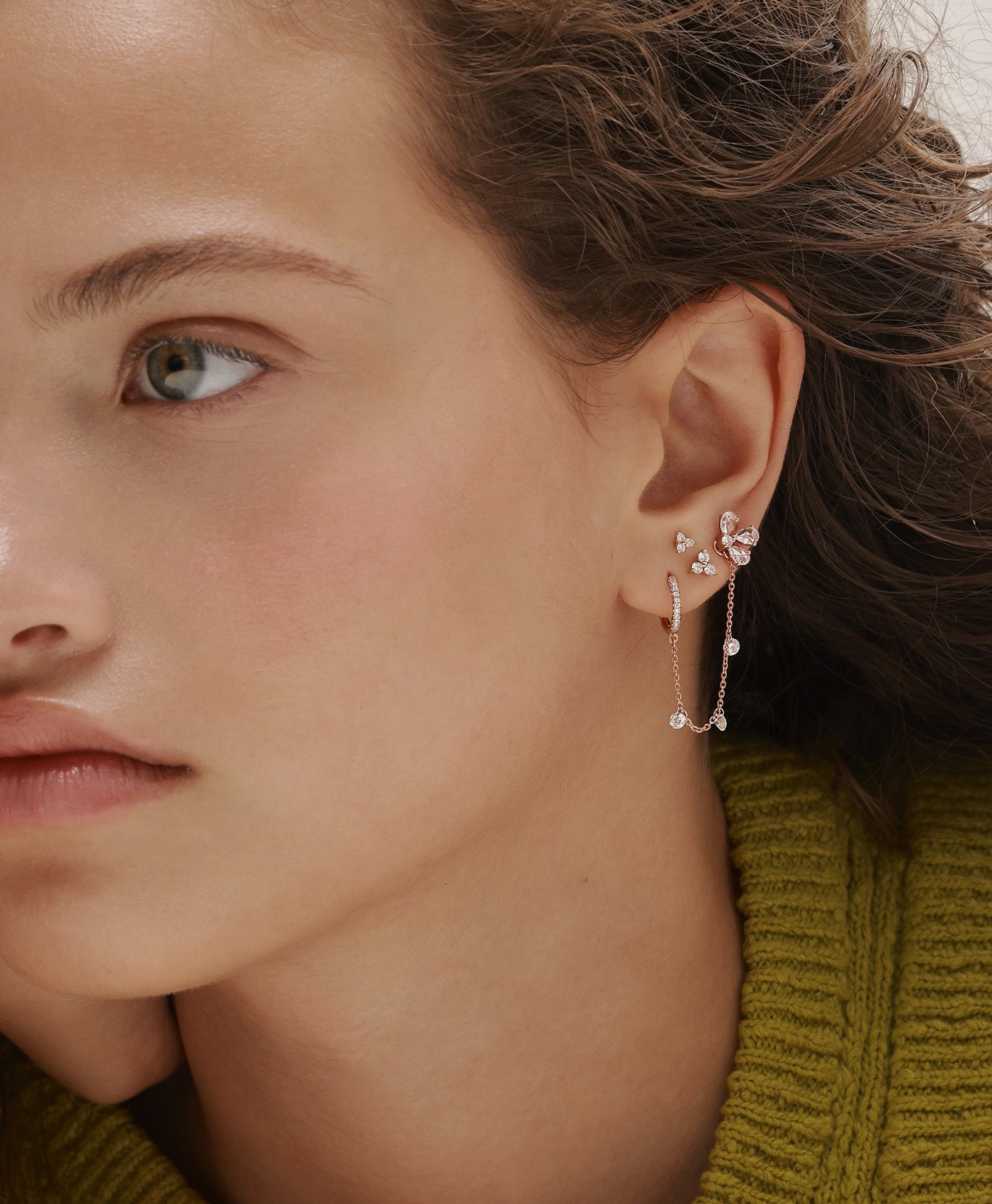 GIA rose gold diamond earring styled with MIA diamond earring in layered ear composition on model
