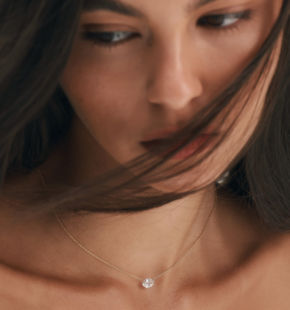 OVAL floating lab diamond necklace worn on model