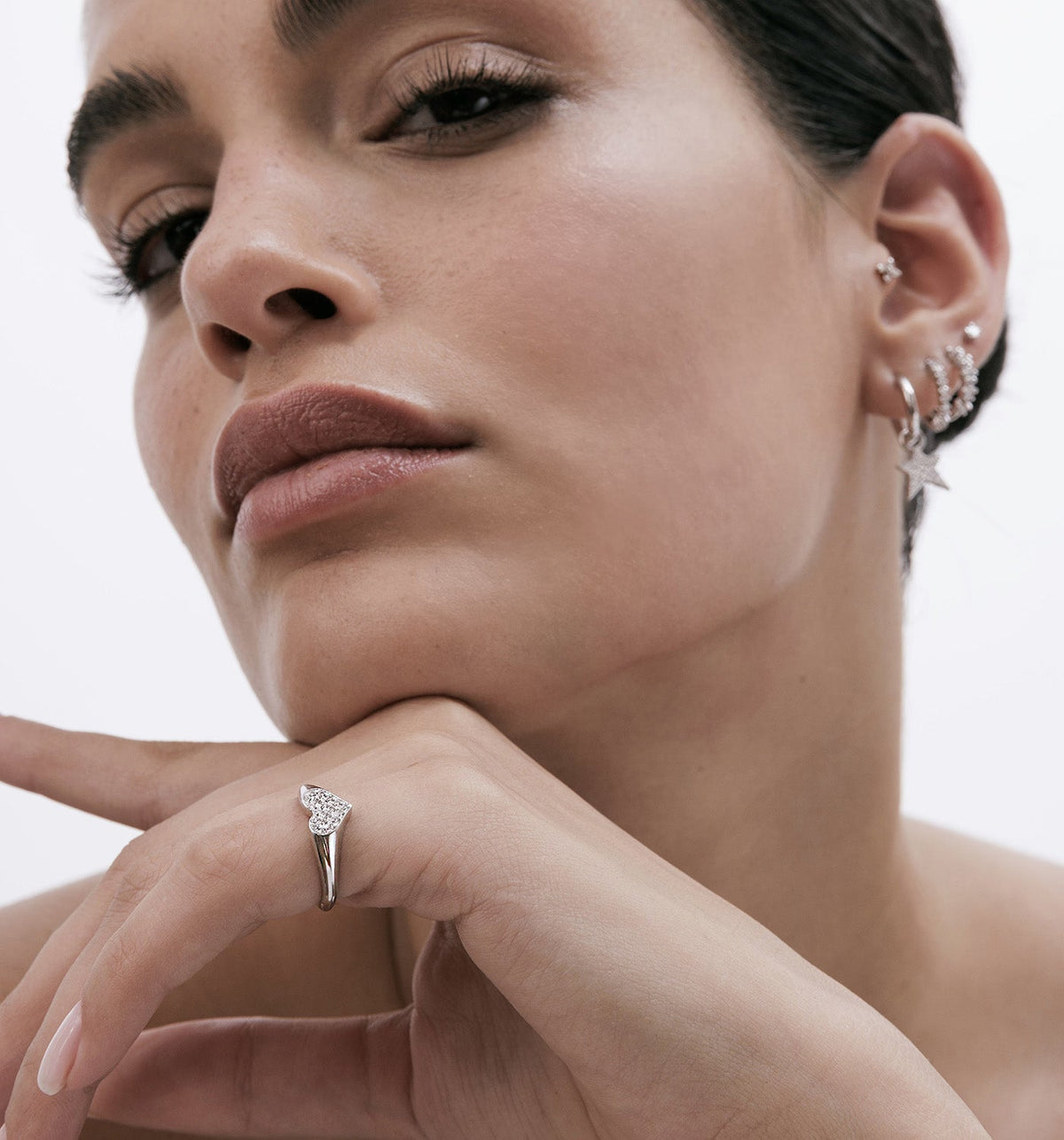 Model wearing a 14K rose gold heart pinky ring set with natural diamonds, styled with GLO
