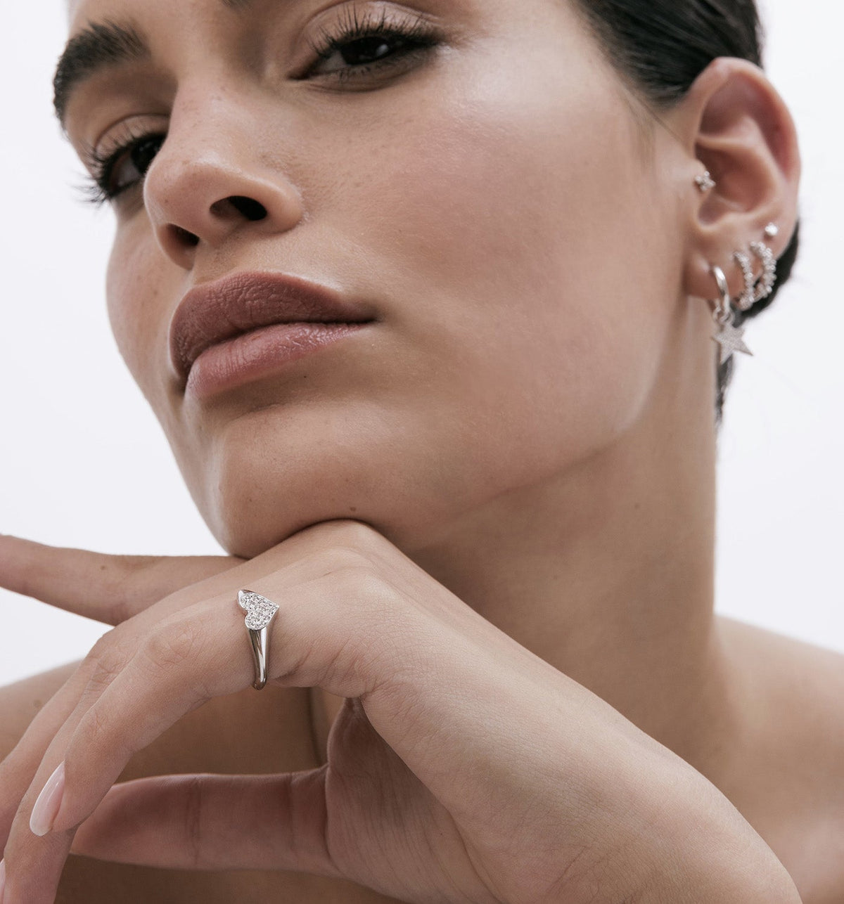 Model wearing a 14K rose gold heart pinky ring set with natural diamonds, styled with GLO