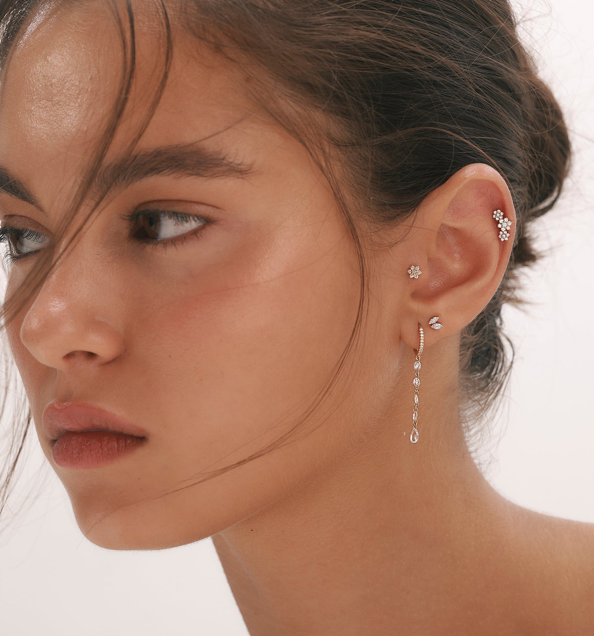Model wearing IRIS, TULIP and RITA rose gold piercing earrings set with natural diamonds.