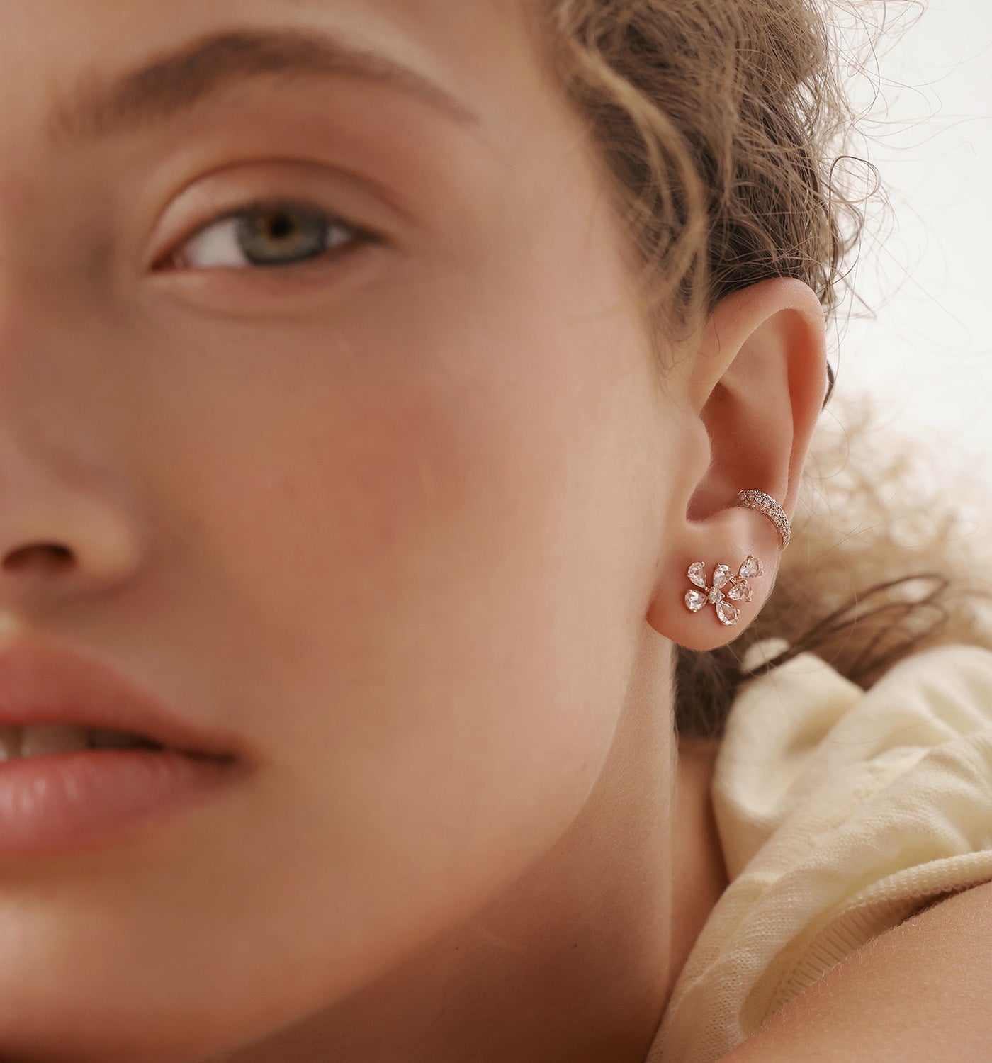 BIANCA asymmetrical diamond earring featured in layered ear jewelry composition on model