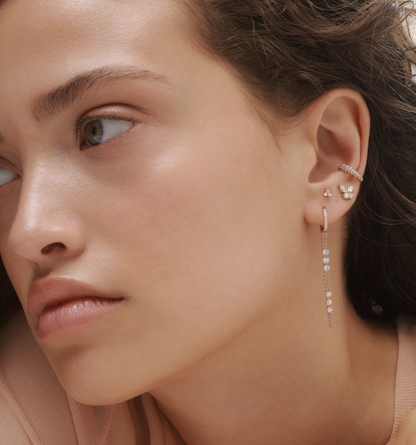 MELANIA flow diamond earring styled with butterfly diamond earring and MAYA ear cuff in curated ear composition on model
