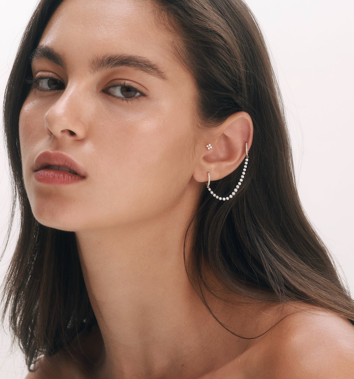 TWIN floating diamond double hoop earrings in rose gold worn on model, featuring floating rose cut diamonds in a curated ear composition